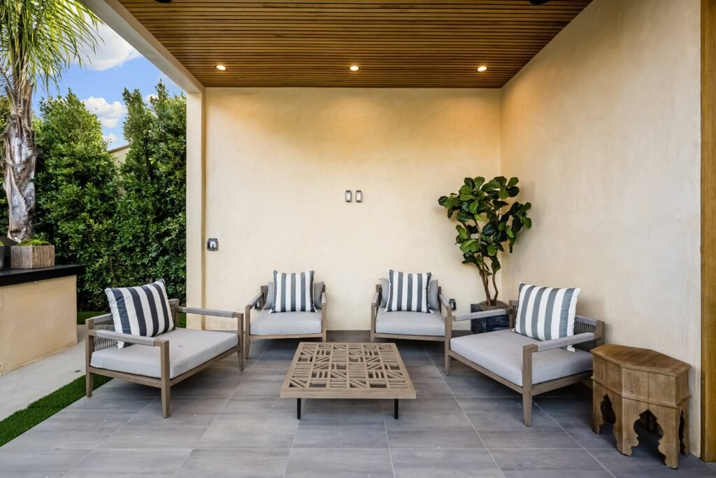Transform Your Covered Patio - A Guide to Floor Ideas modern outdoor patio with cushioned chairs and gre 2024 10 02 16 41 06 utc